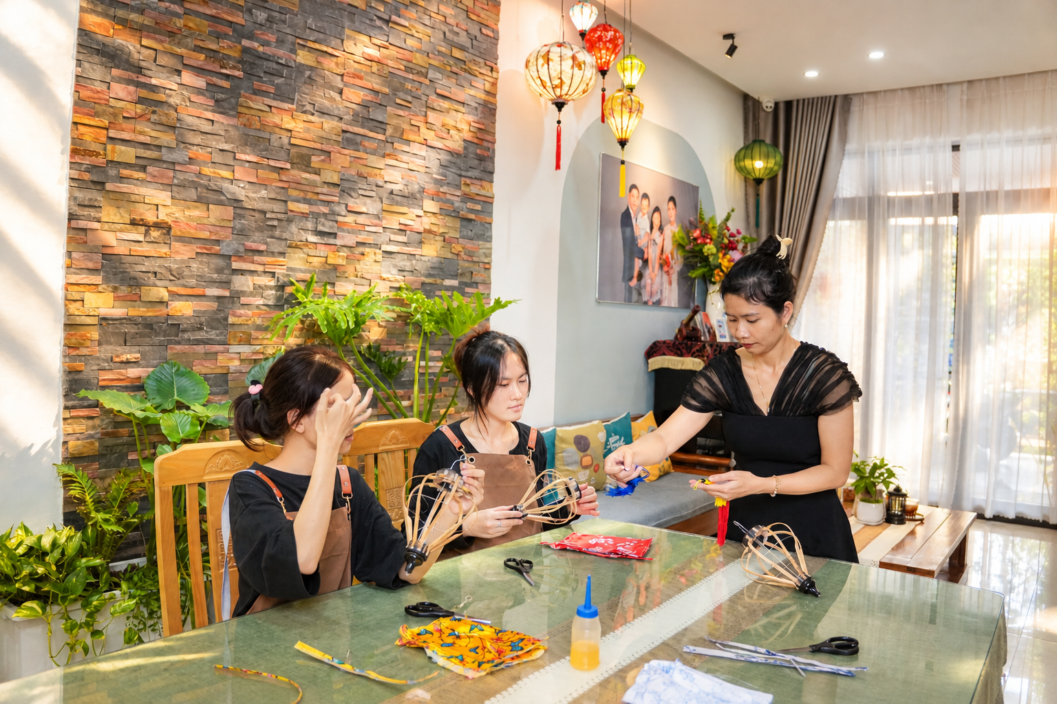 Hands working on a colourful lantern during a workshop in Hoi An